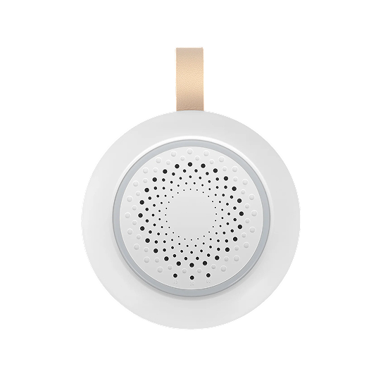 Snoozzie white noise machine on a nightstand